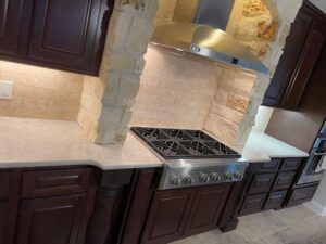 Brown cabinets with Tajamal quartzite